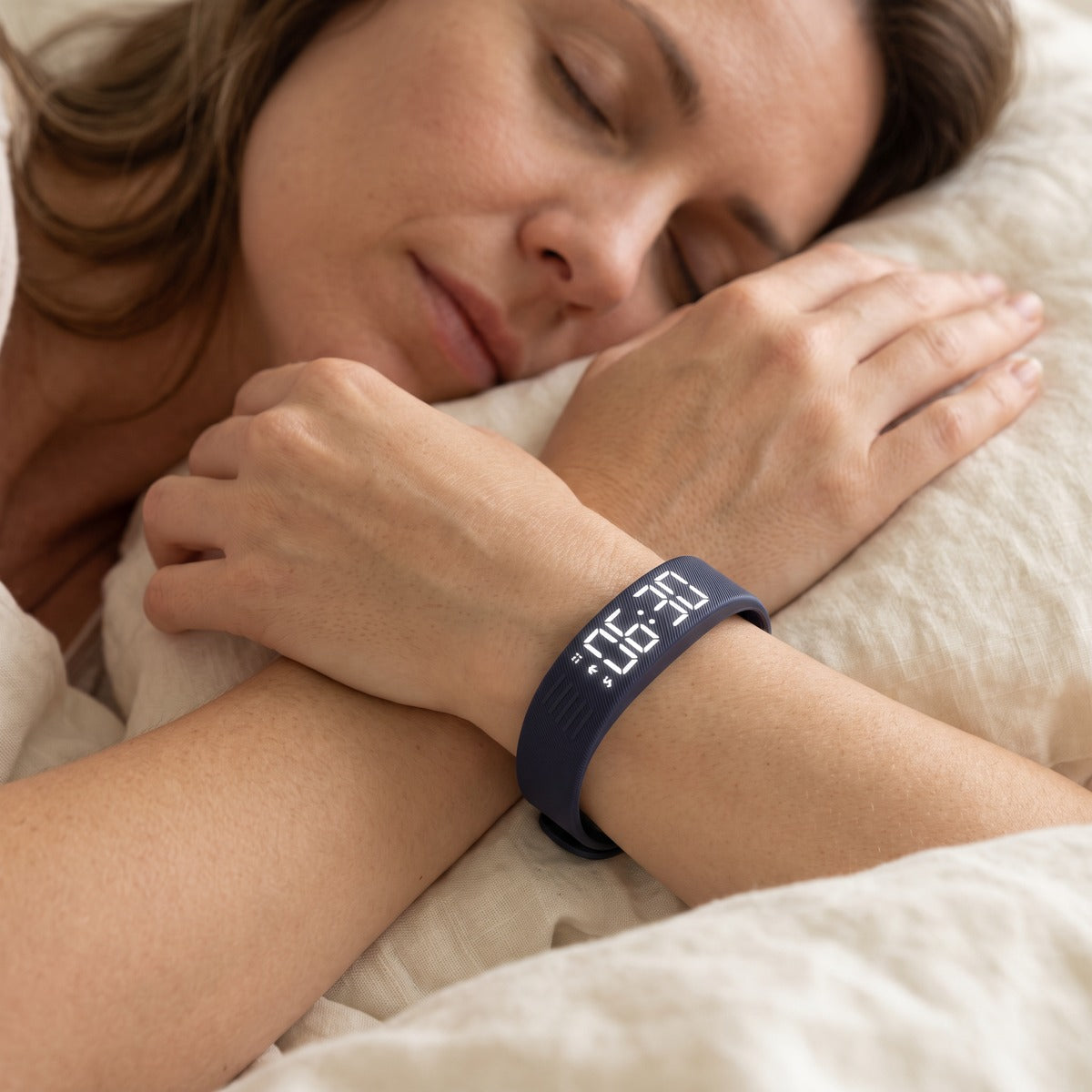 Dark Blue watch worn before bed, with a phone on the bedside table