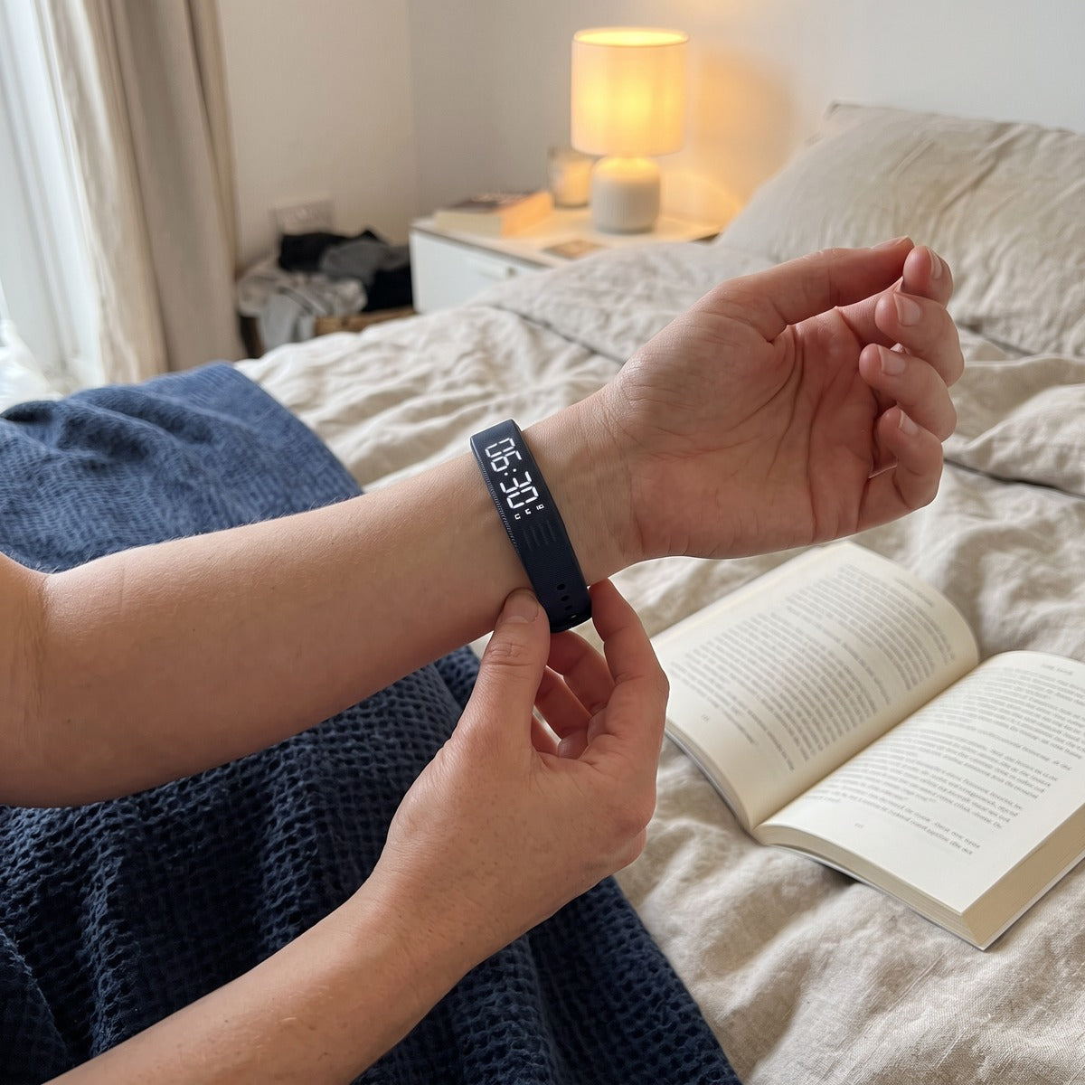 Hands adjusting the Dark Blue silicone strap